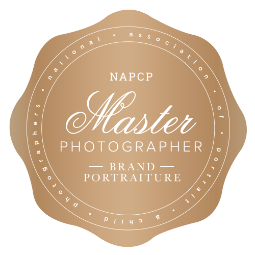 Gold circular seal with 'Master Photographer' center and 'NAPCP' above, 'Brand Portraiture' below, surrounded by ring text.